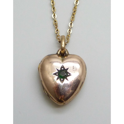 7045 - A c1900 9ct gold locket set with a green stone and on a chain, locket 3.5g