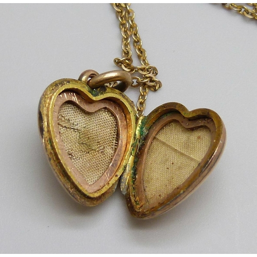 7045 - A c1900 9ct gold locket set with a green stone and on a chain, locket 3.5g