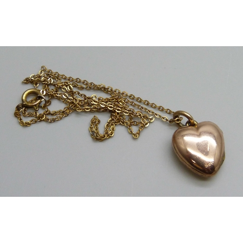 7045 - A c1900 9ct gold locket set with a green stone and on a chain, locket 3.5g