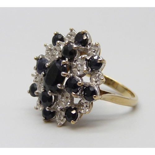 7048 - A vintage 9ct gold sapphire and diamond cluster ring, Birmingham 1987, J½, 4.9g