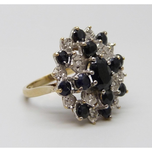 7048 - A vintage 9ct gold sapphire and diamond cluster ring, Birmingham 1987, J½, 4.9g