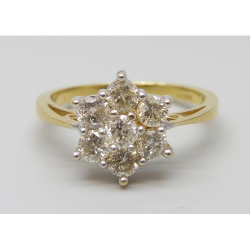 7055 - An 18ct gold seven stone diamond cluster ring, estimated total weight 0.80 carat, M, 3.7g