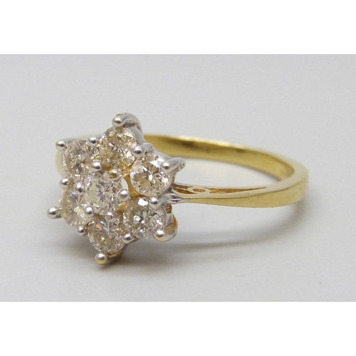 7055 - An 18ct gold seven stone diamond cluster ring, estimated total weight 0.80 carat, M, 3.7g