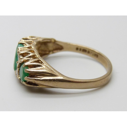 7070 - A 9ct gold, emerald and white stone ring, 3.6g, P