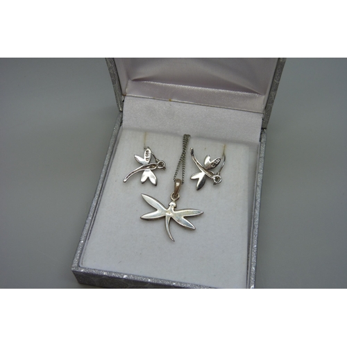 7099 - A silver dragonfly pendant and matching earrings