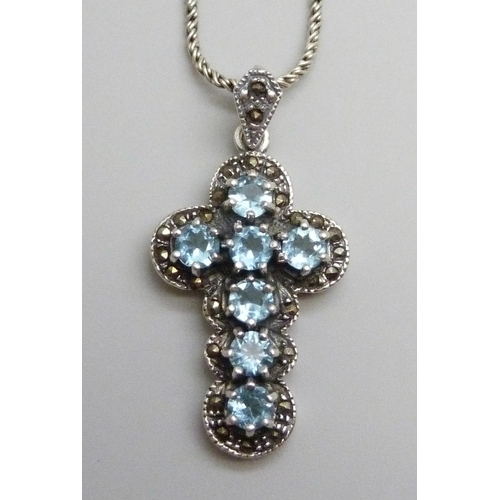 7108 - A silver and topaz cross pendant and chain