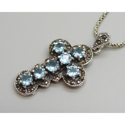 7108 - A silver and topaz cross pendant and chain