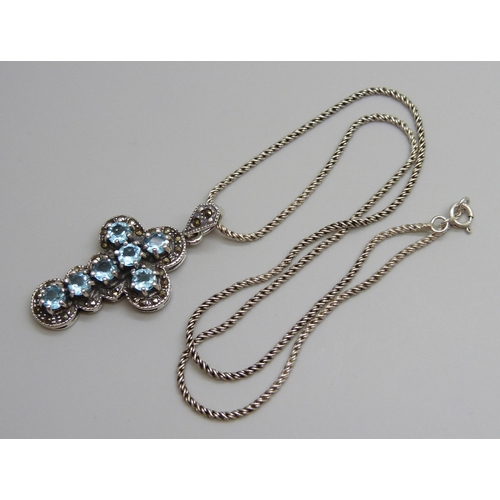 7108 - A silver and topaz cross pendant and chain