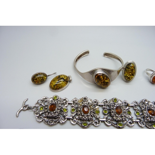 7119 - Two silver and amber set rings, other amber set jewellery and a costume bracelet with loose stone