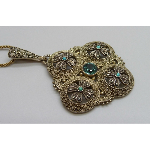 7143 - A Theodor Fahrner silver-gilt pendant set with central tourmaline and small turquoise, artist signat... 