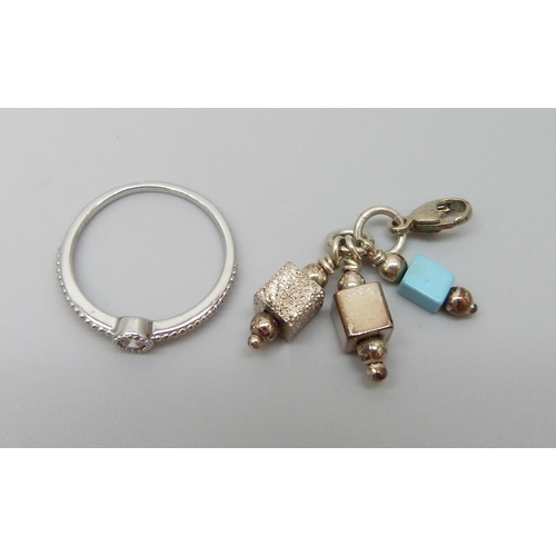 7147 - A silver ring and clip on charm, 4.5g