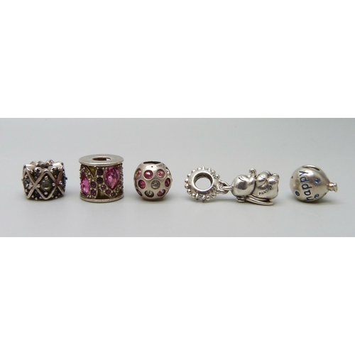 7148 - A collection of five silver charms including one Pandora Disney