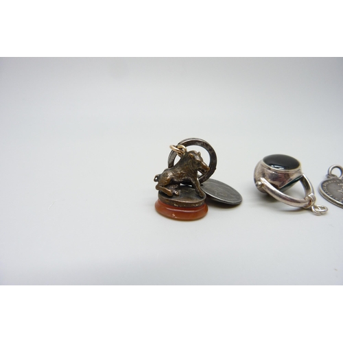 7154 - A swivel fob, a seal fob with wild boar detail and a coin pendant