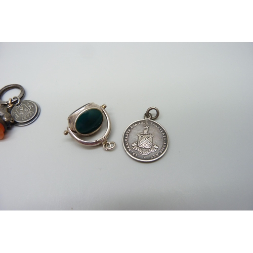 7154 - A swivel fob, a seal fob with wild boar detail and a coin pendant