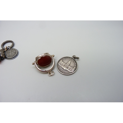 7154 - A swivel fob, a seal fob with wild boar detail and a coin pendant