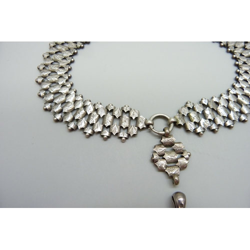 7158 - A Victorian white metal collar necklace and a Victorian hallmarked silver locket, Birmingham 1882