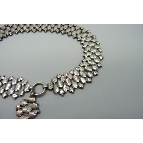 7158 - A Victorian white metal collar necklace and a Victorian hallmarked silver locket, Birmingham 1882