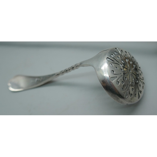 7336 - A silver sifter spoon, 23g, and a toddy ladle inset with a George III silver coin and with baleen ha... 