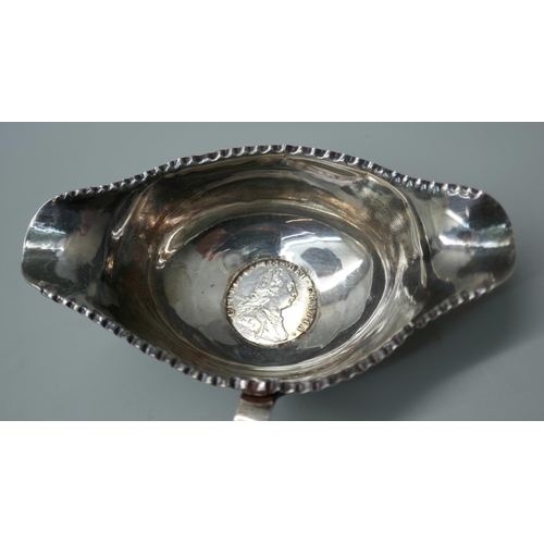 7336 - A silver sifter spoon, 23g, and a toddy ladle inset with a George III silver coin and with baleen ha... 