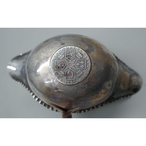 7336 - A silver sifter spoon, 23g, and a toddy ladle inset with a George III silver coin and with baleen ha... 