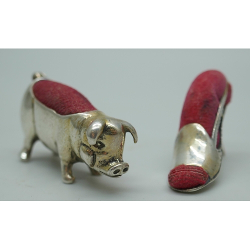 7349 - Two small novelty silver pin cushions, pig and lady's shoe