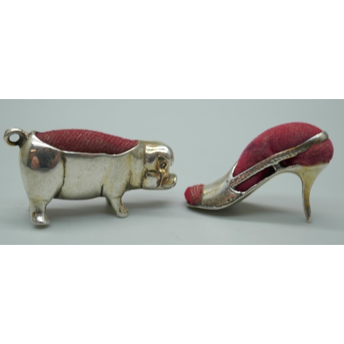 7349 - Two small novelty silver pin cushions, pig and lady's shoe