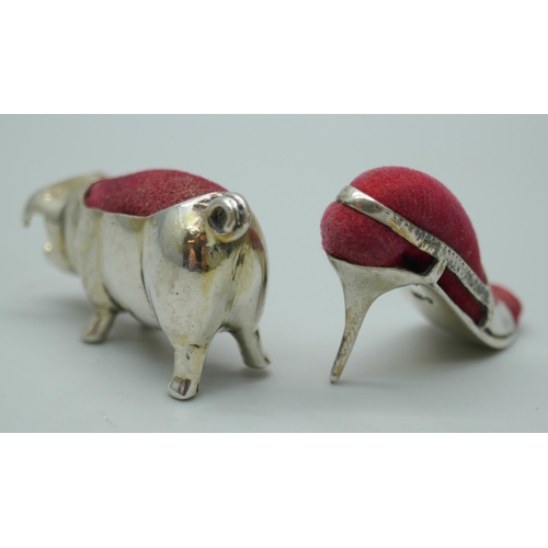 7349 - Two small novelty silver pin cushions, pig and lady's shoe