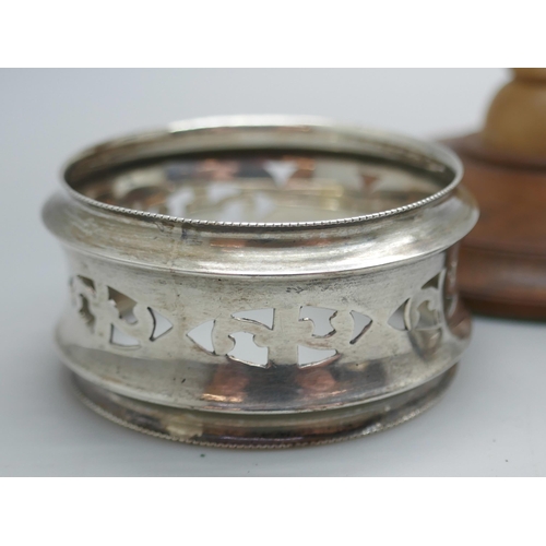 7355 - A wooden stand with silver earrings, a Scottish silver napkin ring and two silver rings, both size N