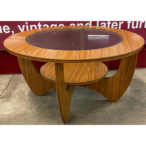 78 - A simulated teak and glass topped circular coffee table