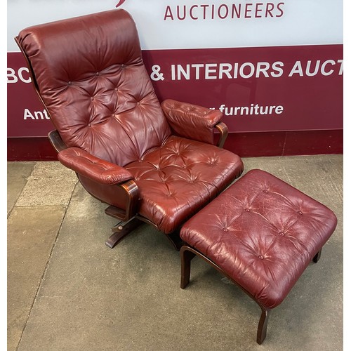 84 - A Scandinavian beech and burgundy leather revolving lounge chair and ottoman