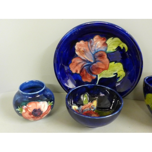 2017 - Five items of early 20th Century Moorcroft china, two vases, two bowls and a dish; Hibiscus, Orchid ... 