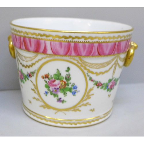 2025 - An 18th Century style continental porcelain cache pot with gilt ring handles, floral swag decoration... 