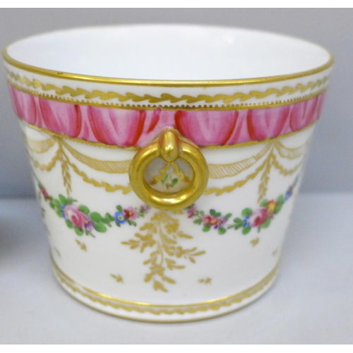 2025 - An 18th Century style continental porcelain cache pot with gilt ring handles, floral swag decoration... 