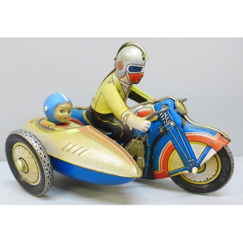 2030 - A vintage tin plate clockwork motorcycle and sidecar