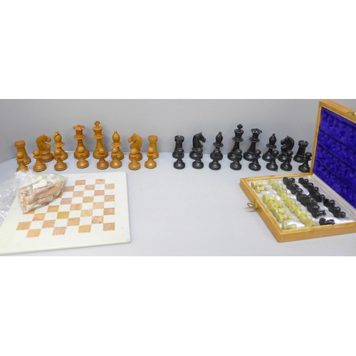 2060 - A wooden chess set, height of king 88mm, a carved stone chess set and board and one other travel set... 