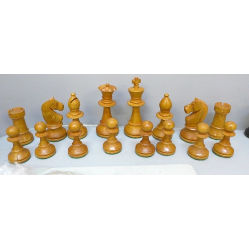 2060 - A wooden chess set, height of king 88mm, a carved stone chess set and board and one other travel set... 