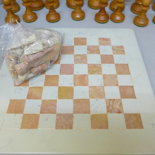 2060 - A wooden chess set, height of king 88mm, a carved stone chess set and board and one other travel set... 