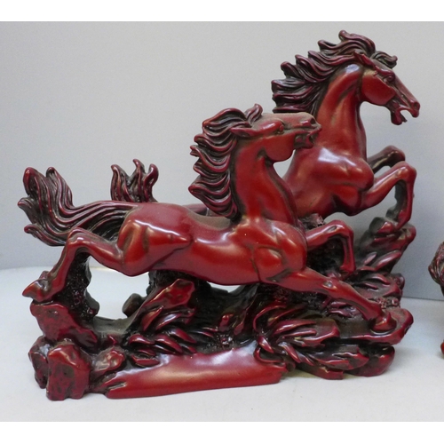 2079 - Two boxed Chinese resin figures; Galloping Horses and Eight Immortals, one Immortal repaired