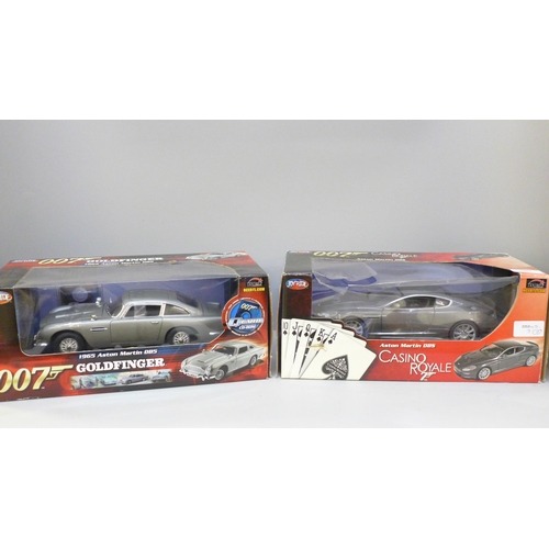 2081 - Two James Bond 007 Joyride cars, Casino Royale Aston Martin DBS and 1965 Aston Martin Goldfinger, bo... 