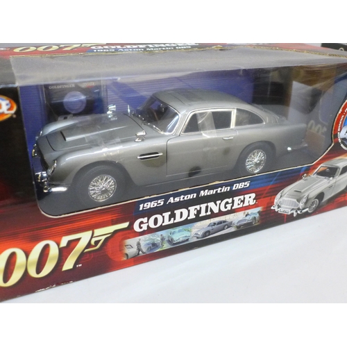 2081 - Two James Bond 007 Joyride cars, Casino Royale Aston Martin DBS and 1965 Aston Martin Goldfinger, bo... 