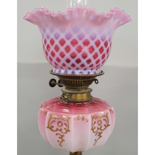 2183 - A tall pink glass and brass oil lamp, 70cm **PLEASE NOTE THIS LOT IS NOT ELIGIBLE FOR IN-HOUSE POSTI... 