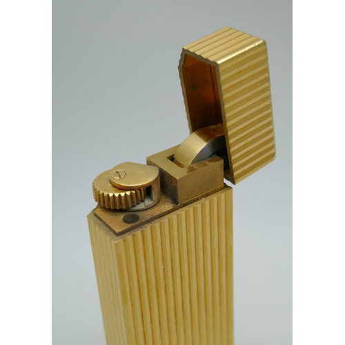 2301 - A Cartier gold plated lighter, numbered 1078234