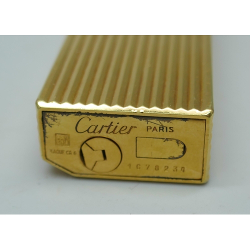 2301 - A Cartier gold plated lighter, numbered 1078234