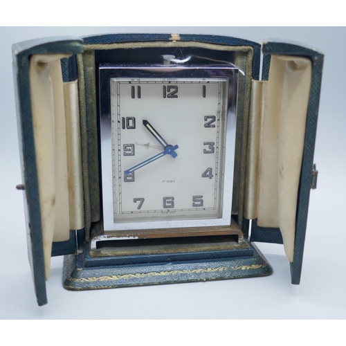 2302 - An Art Deco 8-Day travelling timepiece, in fitted case marked Harrods, London, S.W.1.