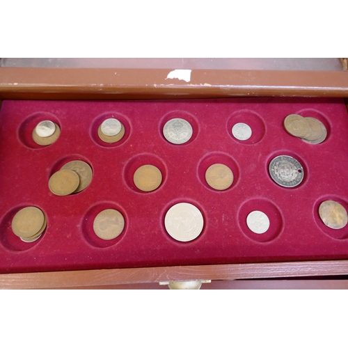 2311 - A collectors cabinet with coins and a WWII medal