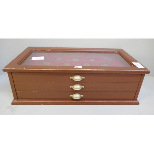 2311 - A collectors cabinet with coins and a WWII medal