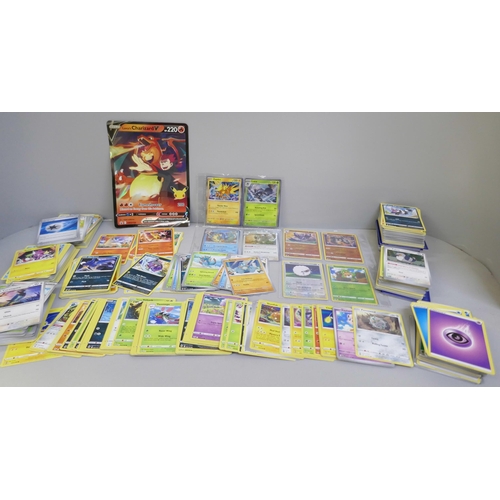 2312 - A box of over 600 Pokémon cards including holographic and rare cards with a large promo card