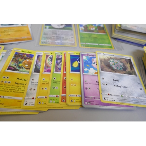 2312 - A box of over 600 Pokémon cards including holographic and rare cards with a large promo card