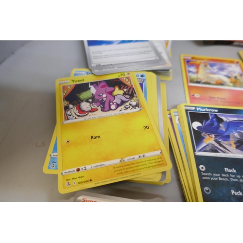 2312 - A box of over 600 Pokémon cards including holographic and rare cards with a large promo card