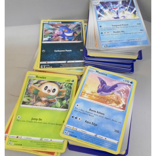 2312 - A box of over 600 Pokémon cards including holographic and rare cards with a large promo card